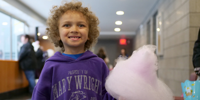 Child eating cotton candy at the Family Day event